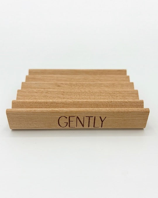 Wooden Gently Soap Tray set against a white background, displaying its grooved top.