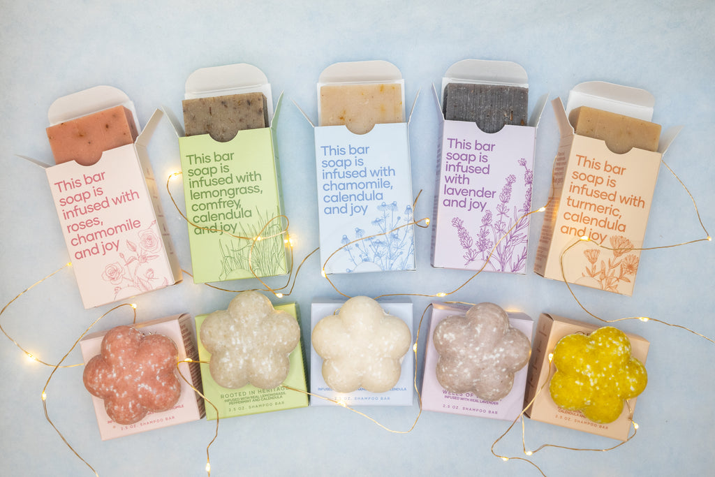 Set of soap bars with their packaging on a light blue background